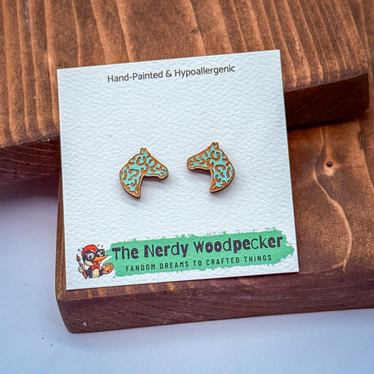 a pair of earrings with a wooden packaging, featuring a cartoon character and text related to the earrings.