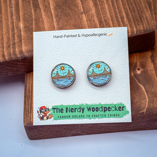 a pair of earrings displayed on a wooden surface, with a card that provides information about the earrings.