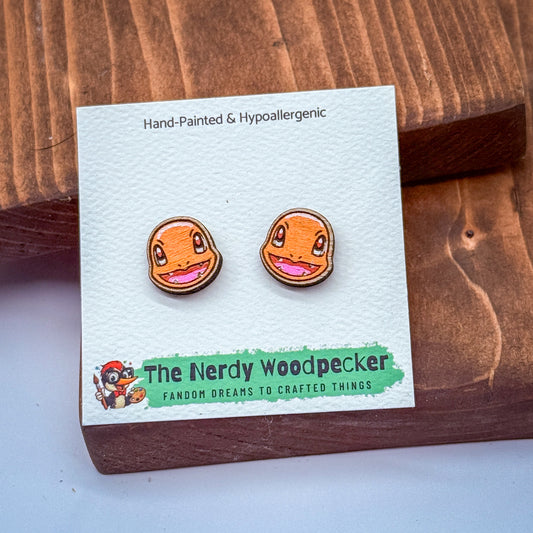 A pair of hand-painted and hypoallergenic earrings featuring cartoon-style Pokemon characters, as described on the packaging.