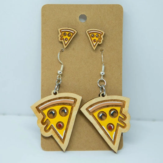 A pair of earrings featuring wooden pizza slice designs, with the earrings and their corresponding pins displayed on a brown card.