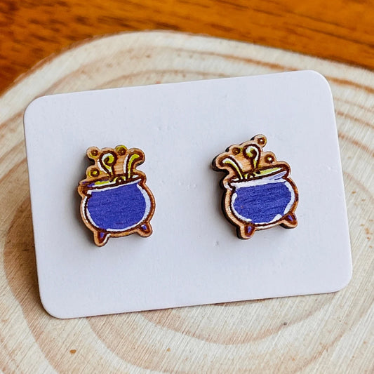 A pair of wooden earrings with blue pots on a white background.