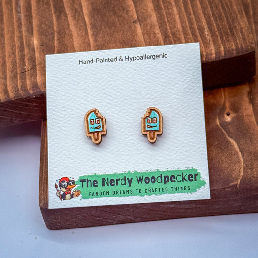 a pair of earrings with a hand-painted and hypoallergenic design, presented on a wooden surface.