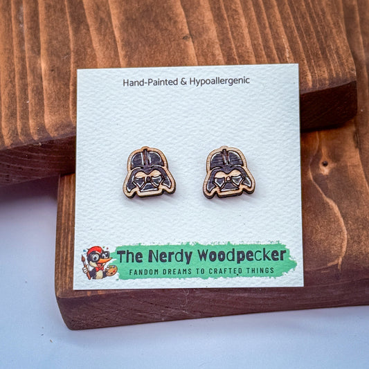 a pair of hand-painted wooden earrings with a hypoallergenic design, placed on a wooden surface.